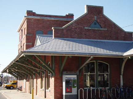 A red brick building with a classic architectural design and large windows.